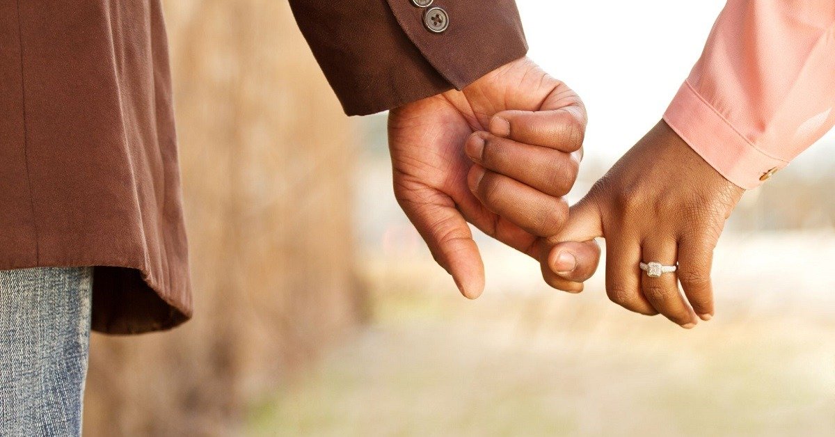 close up of man holding womans hand