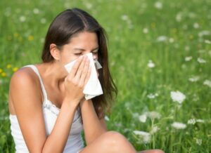 woman sneezing because of hayfever season