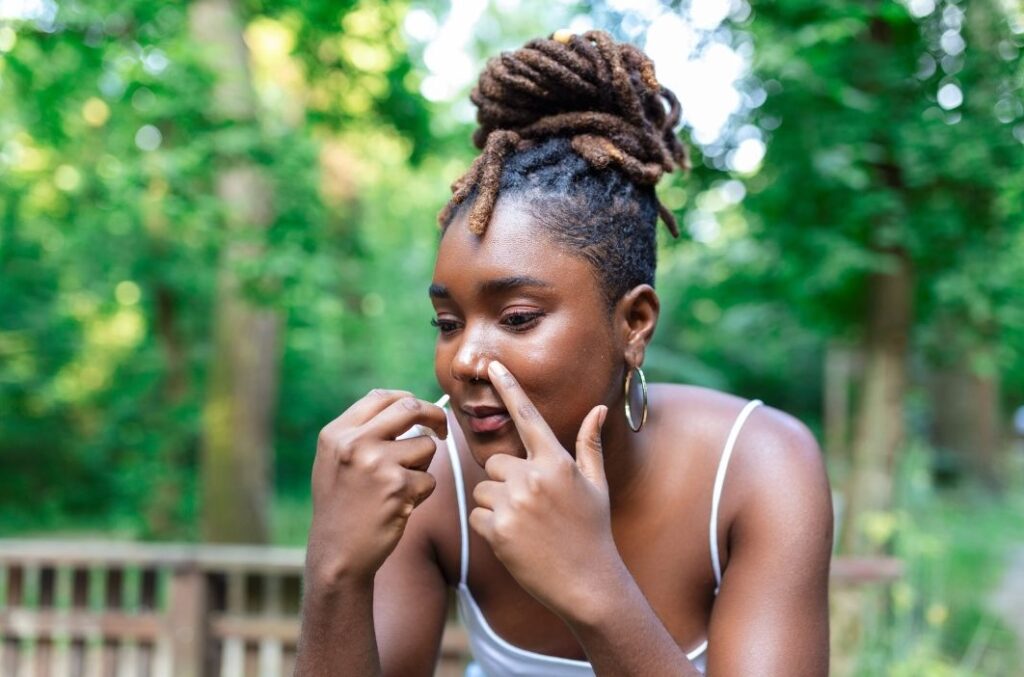 woman using a hayfever nasal spray