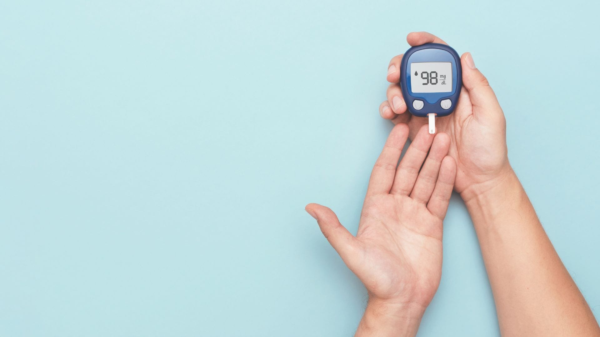 A person using a glucose meter to check blood sugar levels.