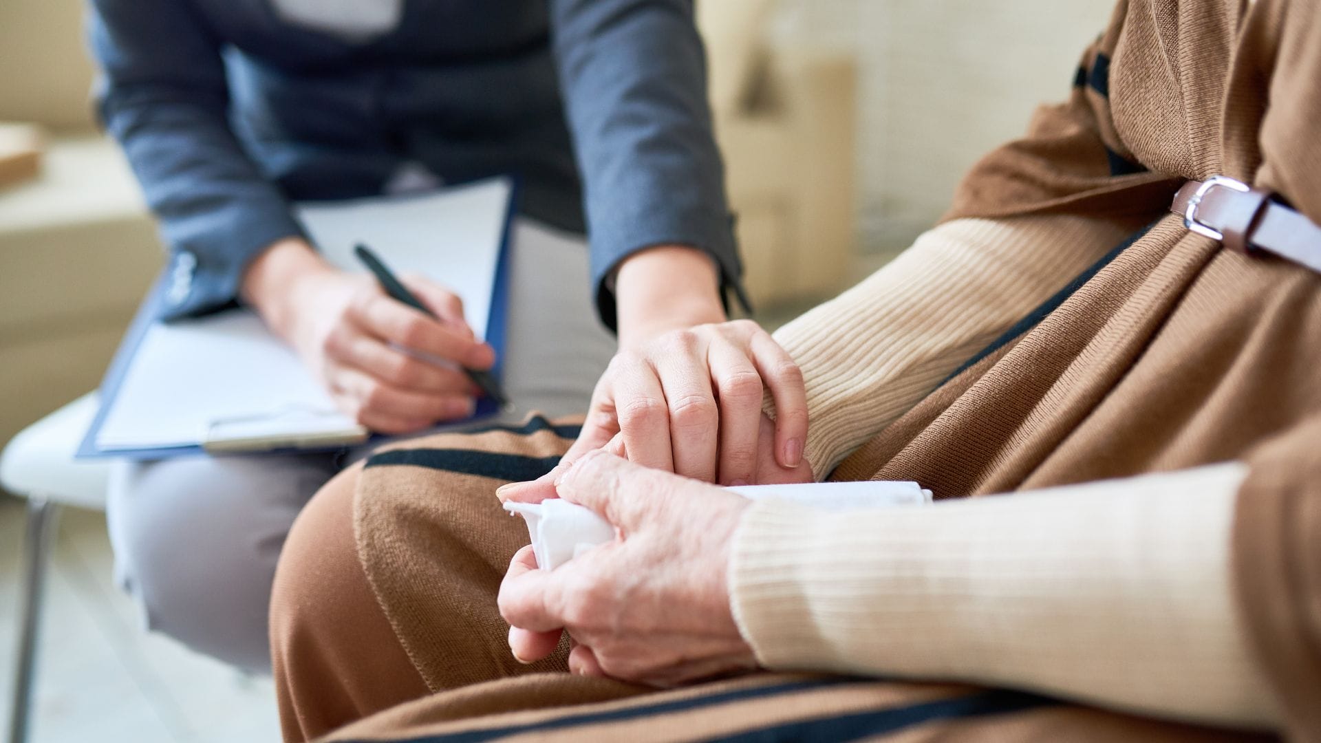 Supporter holding hands with an person during a session.