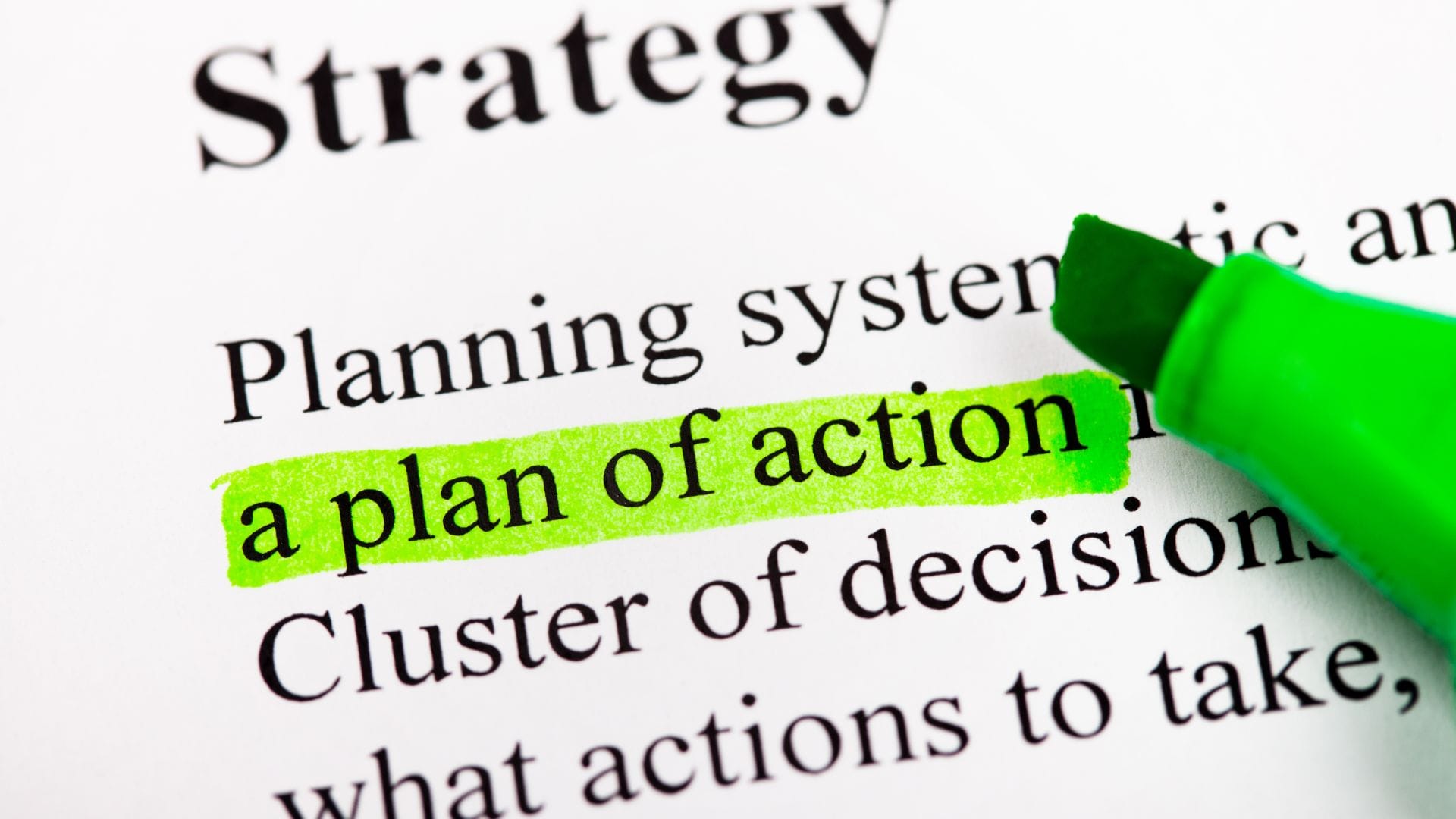 A printed document with "a plan of action" highlighted in green.