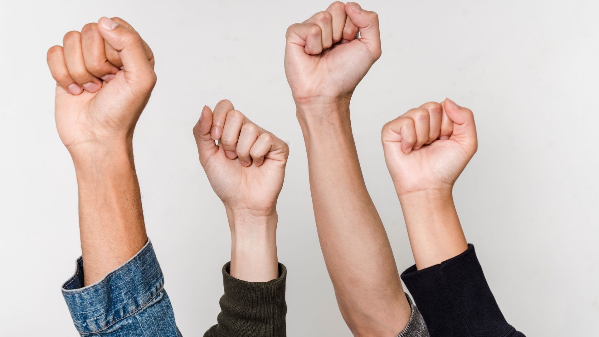 Four raised fists showing unity and empowerment.