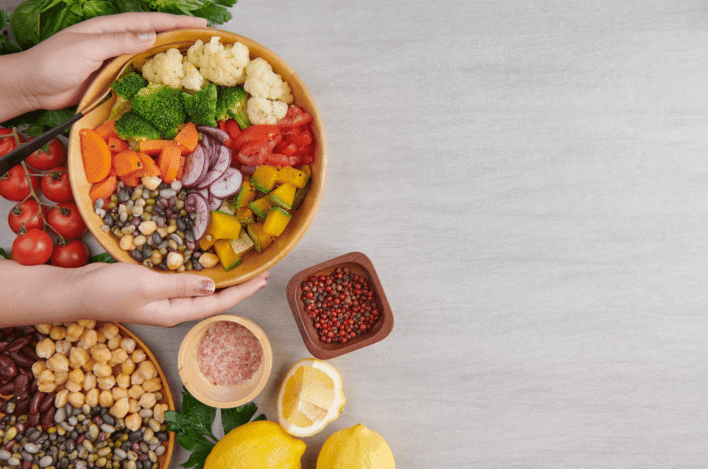 Colourful bowl of vegetables, beans and fresh ingredients, representing balanced nutrition compared with restrictive fad diets.