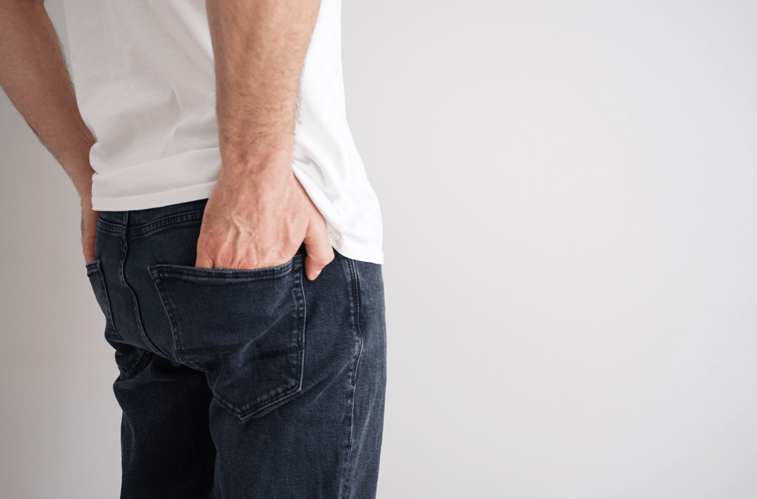 Man standing with one hand in his back pocket, representing concerns about premature ejaculation before starting medication.